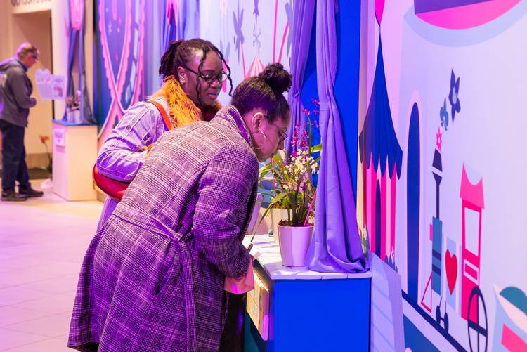 A visitor smells an orchid at the Cleveland Botanical Garden annual Orchid show.
